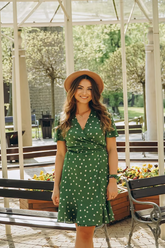 a lady wears a green wrap dress